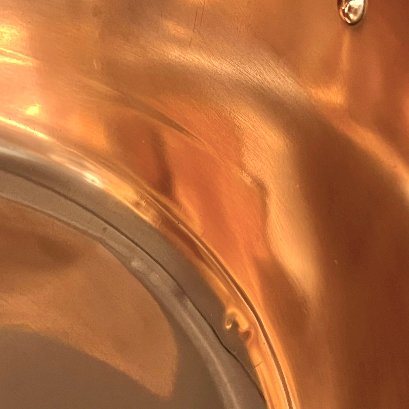 Close up of a copper sink on a white background 