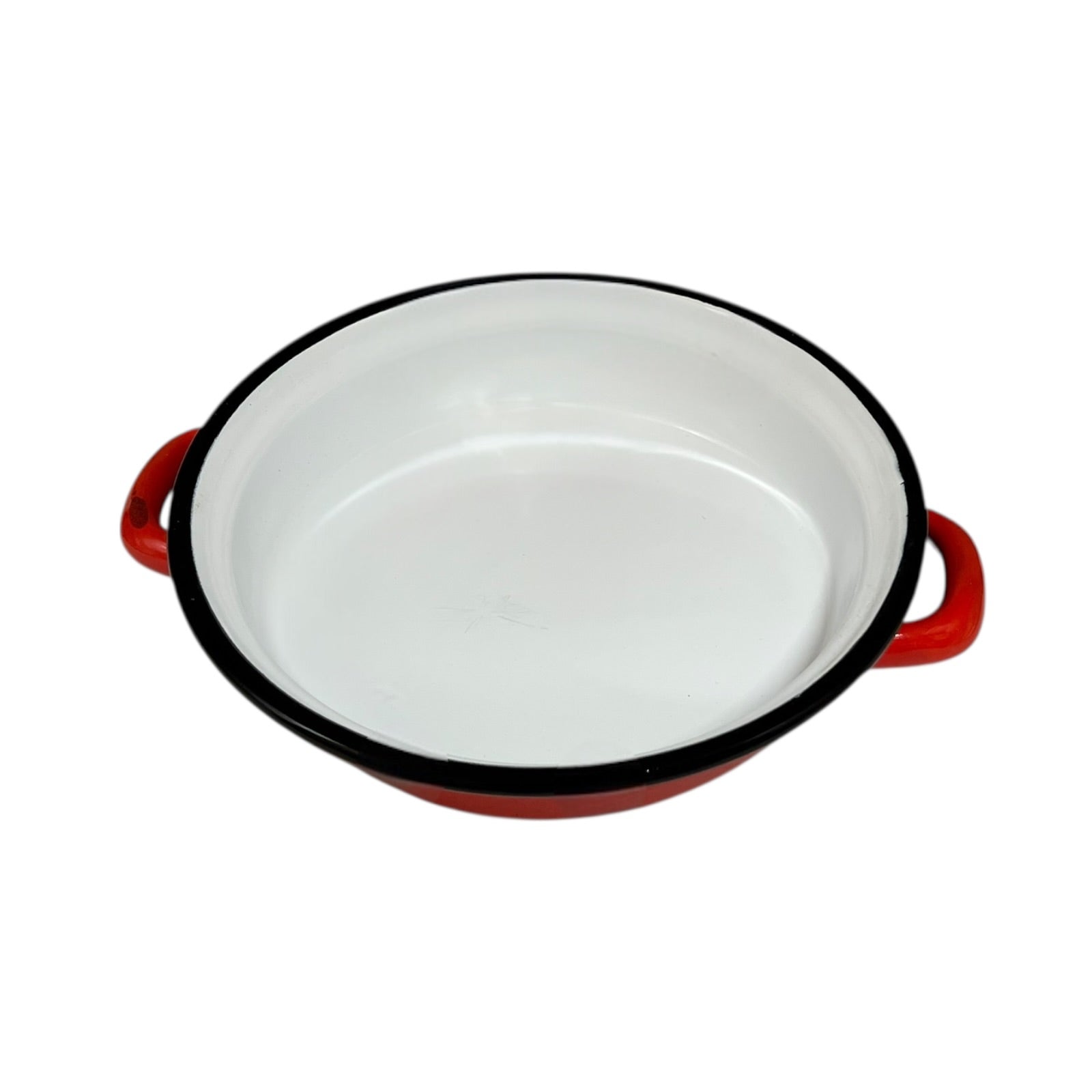 Red enamelled French vintage skillet with black rim on a white background