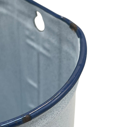 French vintage enamel irrigator jug, white and blue with a handle and a small spout on a white background