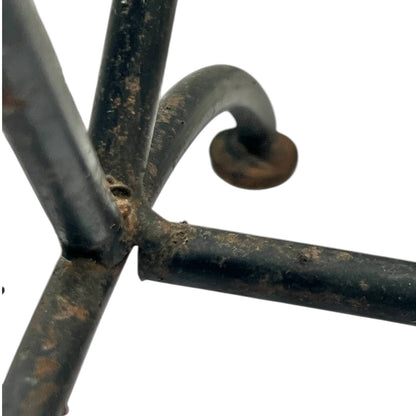 Close-up of a black metal stand on a white background