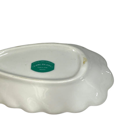 White ceramic dish with a green label on a white background