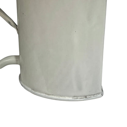 Close up of  French vintage enamel planter with a flat back and a spout on a white background
