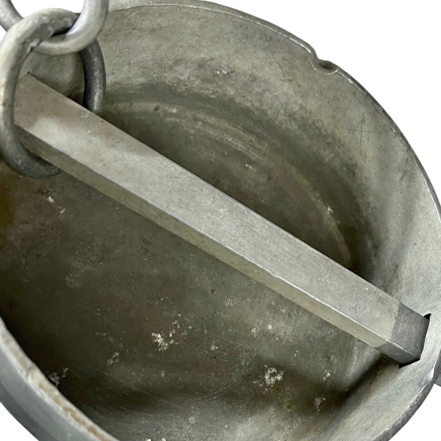 Metal milk churn lid with chain inside a metal container on a white background