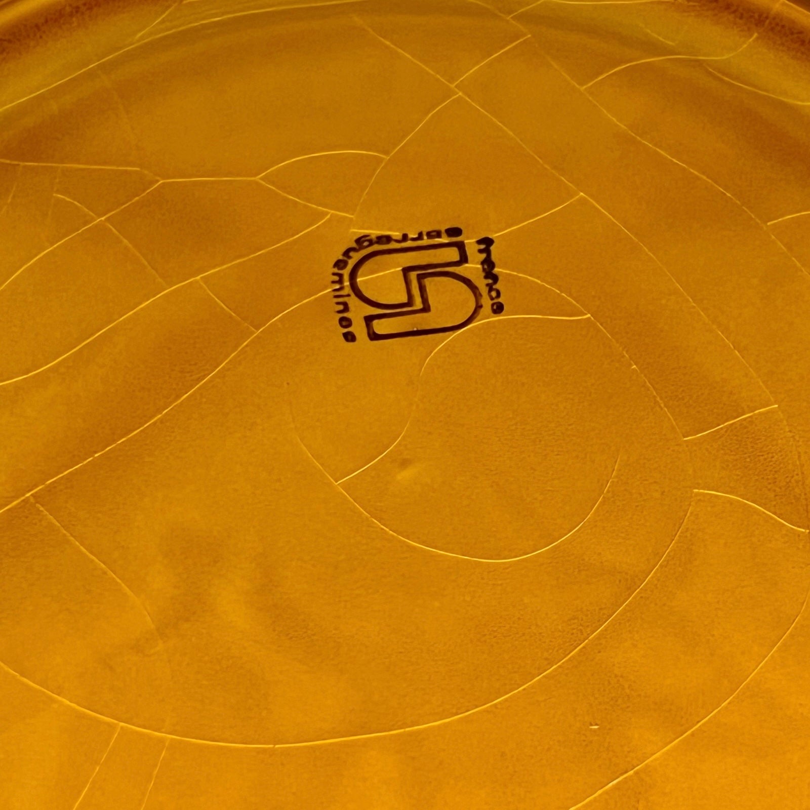 Back of fondue plate showing makers stamp on a white background