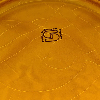 Back of fondue plate showing makers stamp on a white background