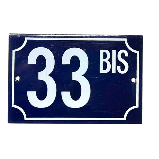 Navy blue rectangular sign with white text '33 BIS' on a white background