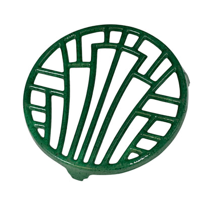 Green vintage French cast iron enamelled pan trivet on a white background