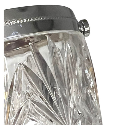 Close up of a French vintage glass ice bucket with silver rim on a white background