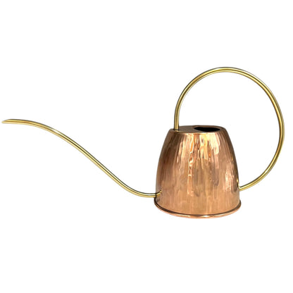Copper watering can with a brass handle and spout on a white background