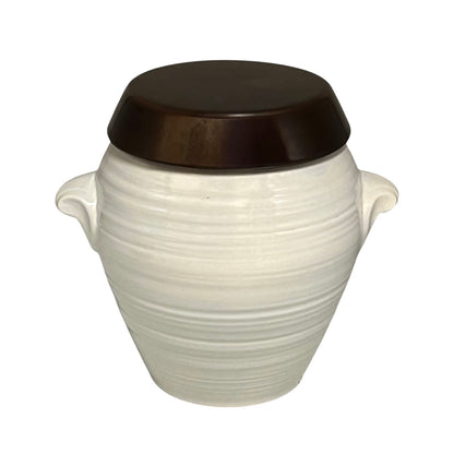 A ceramic canister with a ribbed white body, side handles, and a dark brown lid, shown against a plain white background.