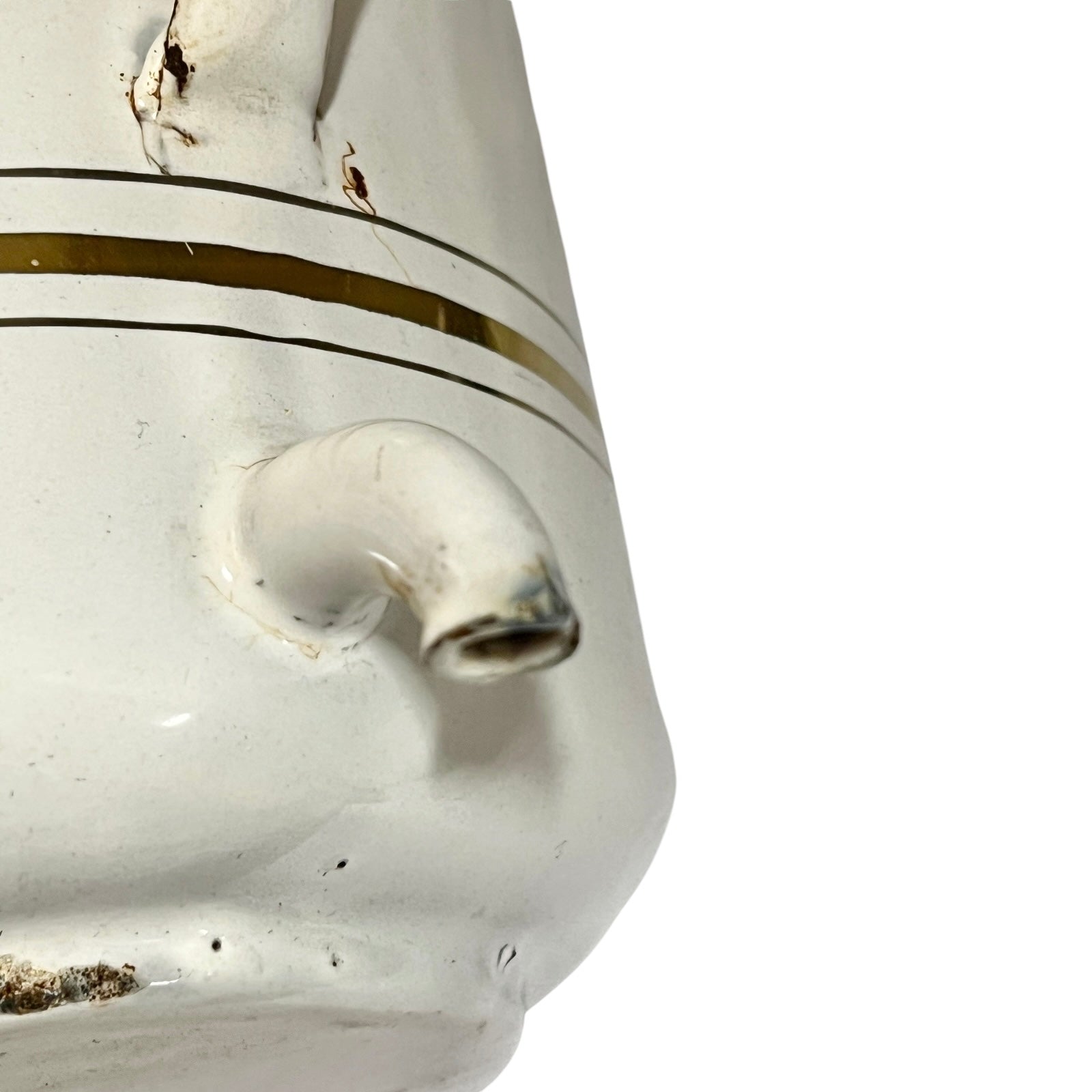 Close-up of a white ceramic pitcher or teapot with a curved spout, featuring thin gold stripes and a glossy glaze, set against a plain white background.