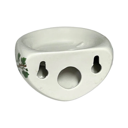 Porcelain bathroom toothbrush holder  featuring green leaf patterns on a white background
