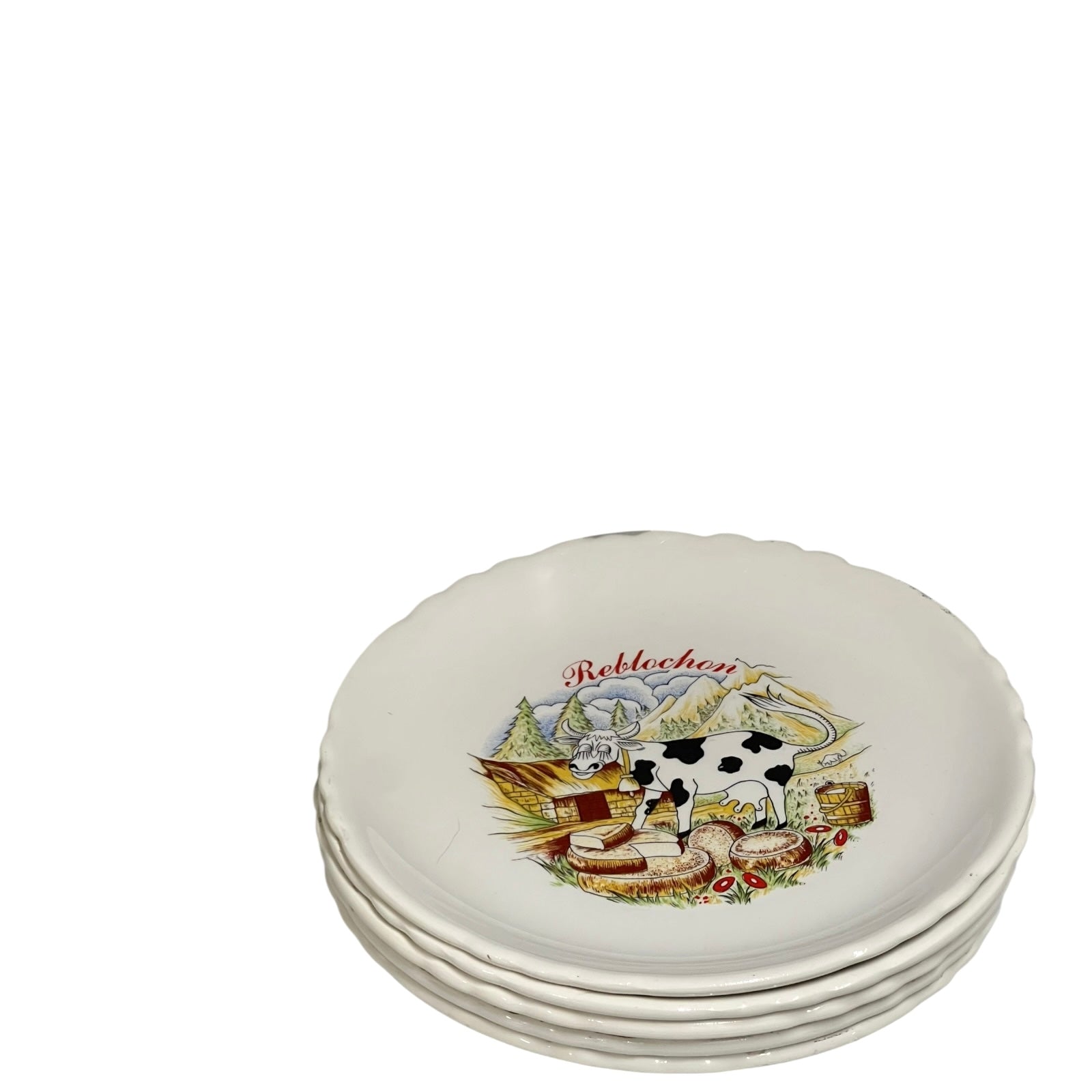 Set of ceramic plates with cow and landscape design on a white background