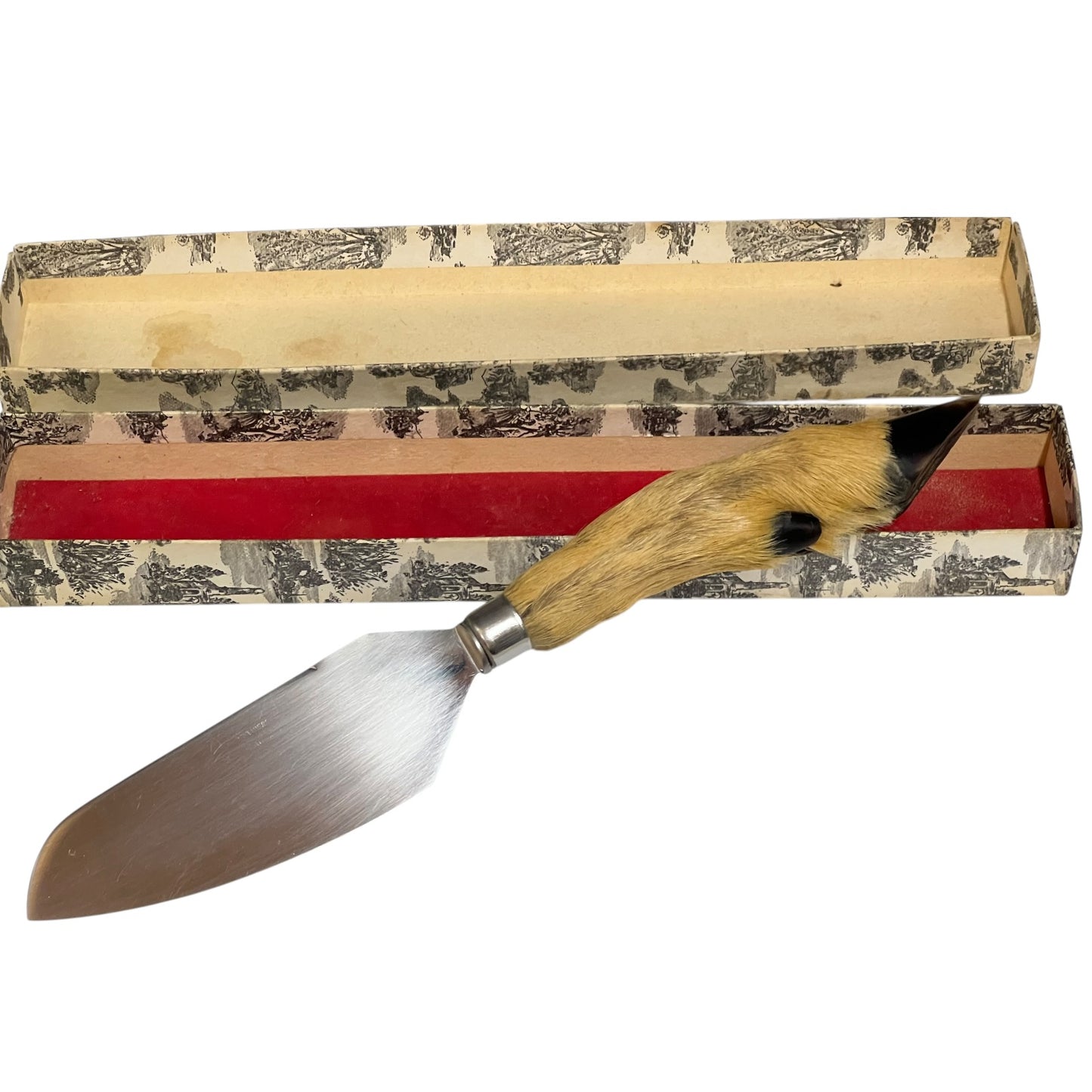 A vintage pastry or cake turner with a polished steel blade and a curved handle made of natural deer antler, resting diagonally in front of its patterned presentation box.