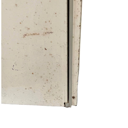 close up of a vintage metal bathroom cabinet on a white background