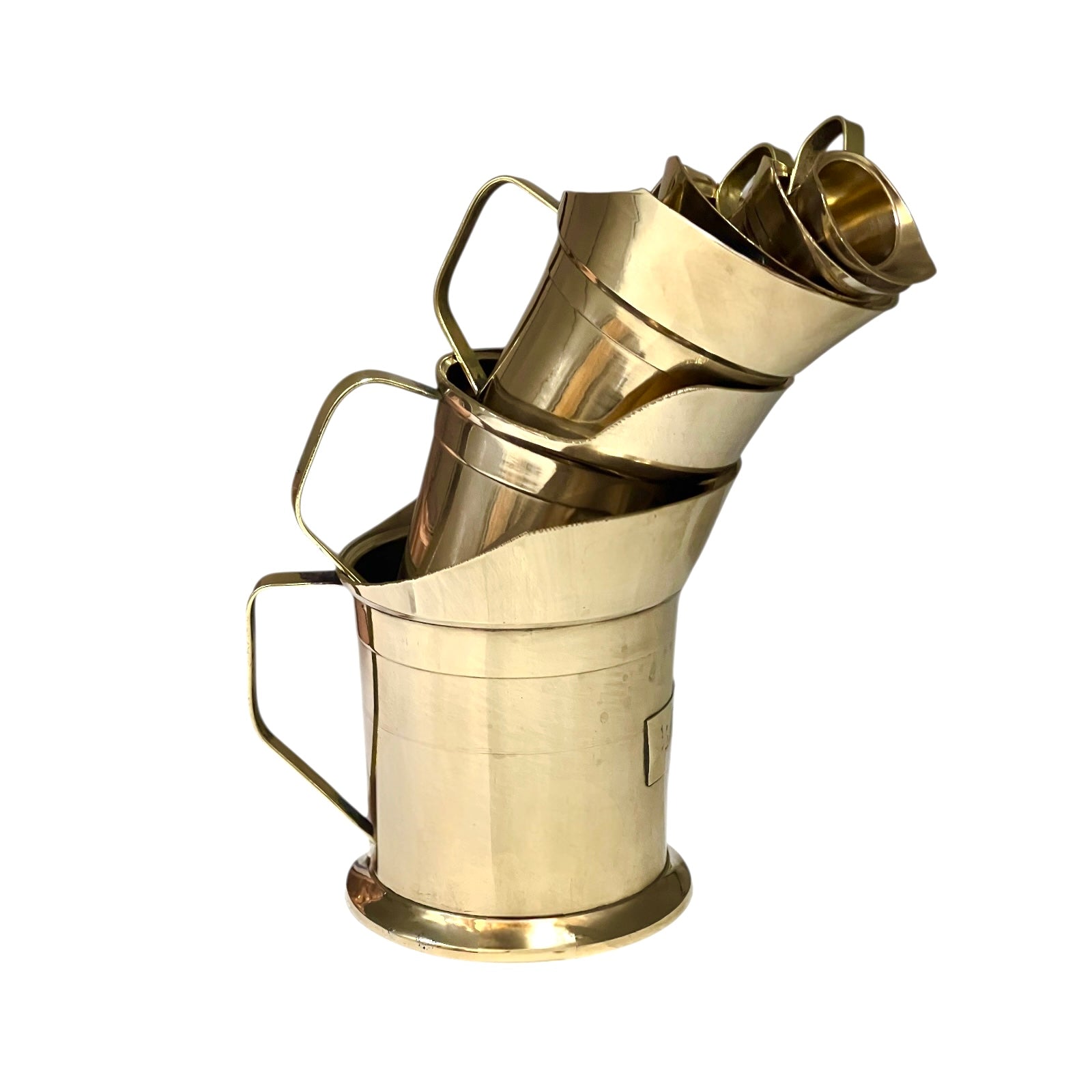 Stack of brass measuring cups on a white background