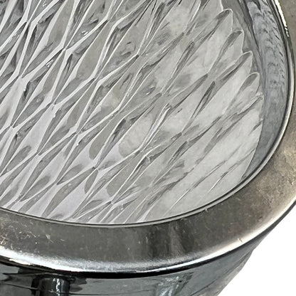Close up of a French vintage glass ice bucket with a silver coloured collar and a handle on a white background 