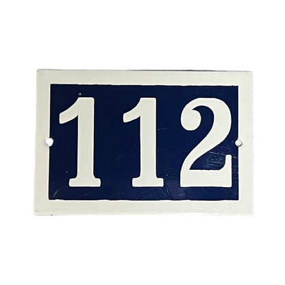 French enamel blue and white front door number 112 with a white border on a white background