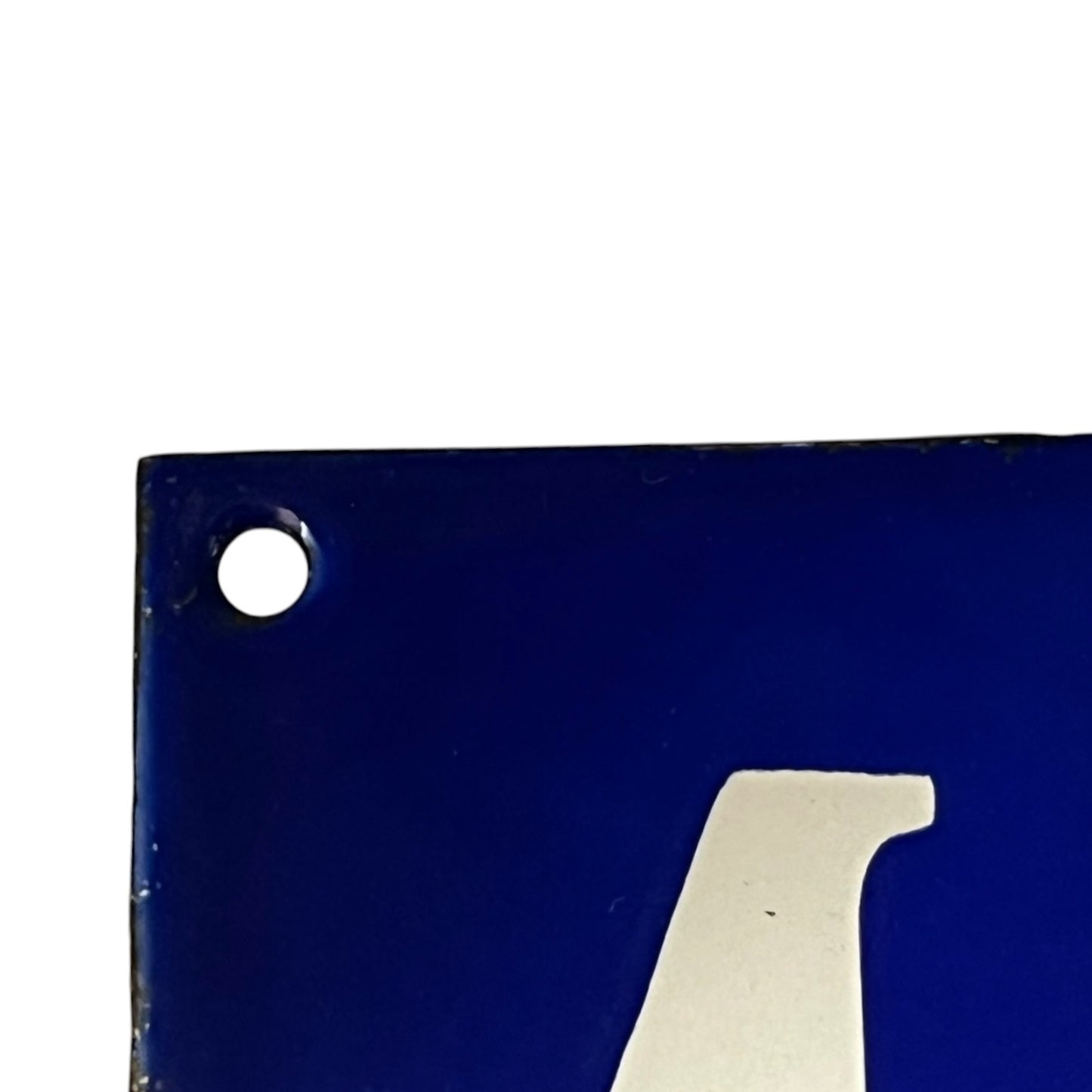 Blue metal sign with a white number '4' on a white background