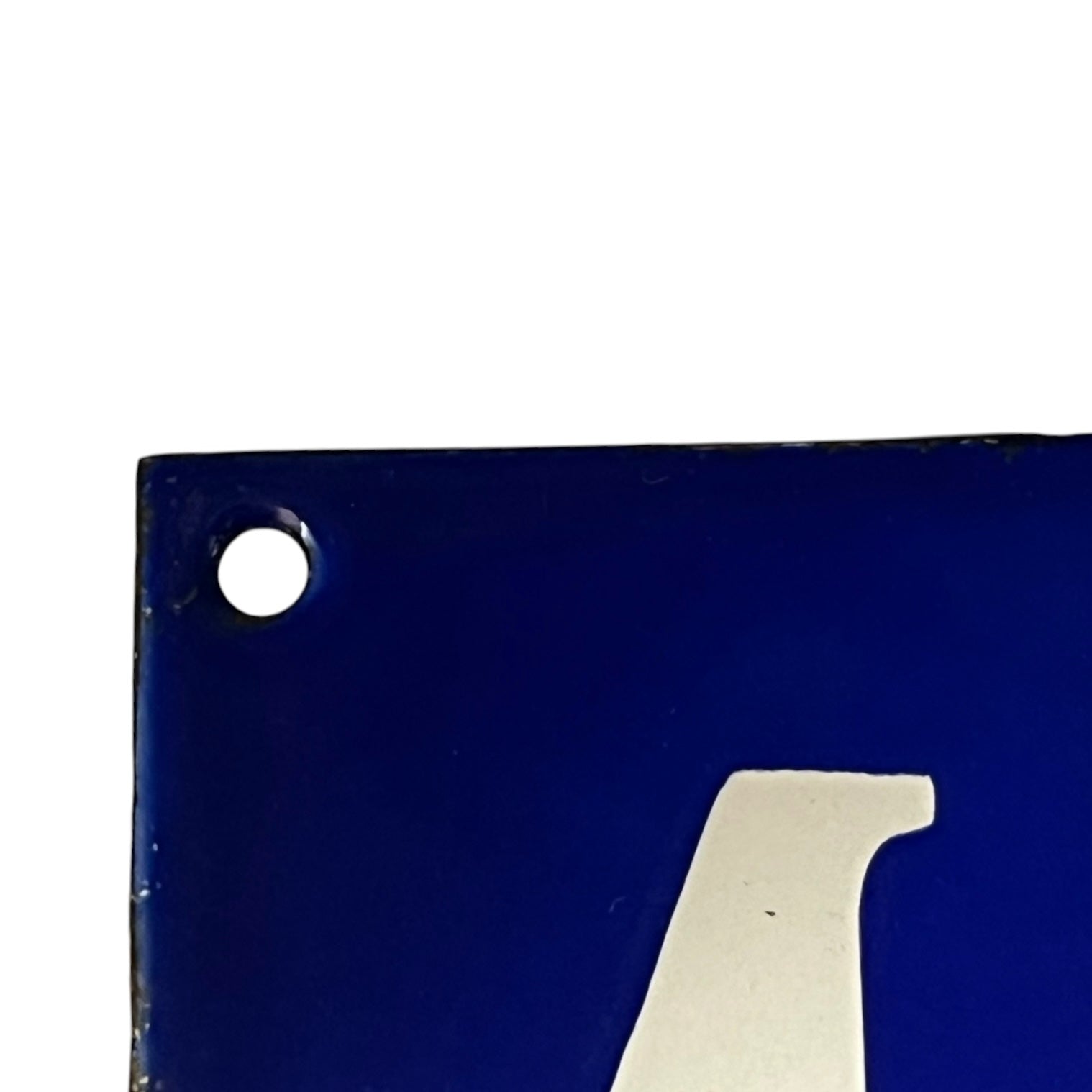 Blue metal sign with a white number '4' on a white background