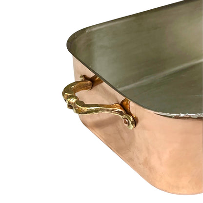 Copper roasting pan with tin lining on a white background