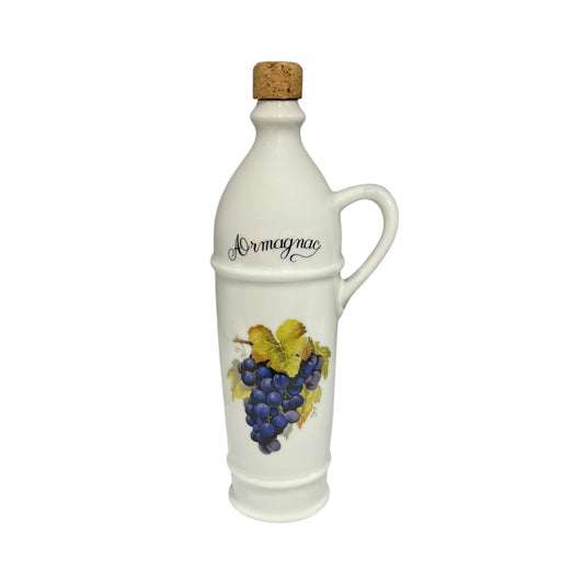 White ceramic bottle with a cork top, decorated with grapes, on a white background for sale from All Things French Store