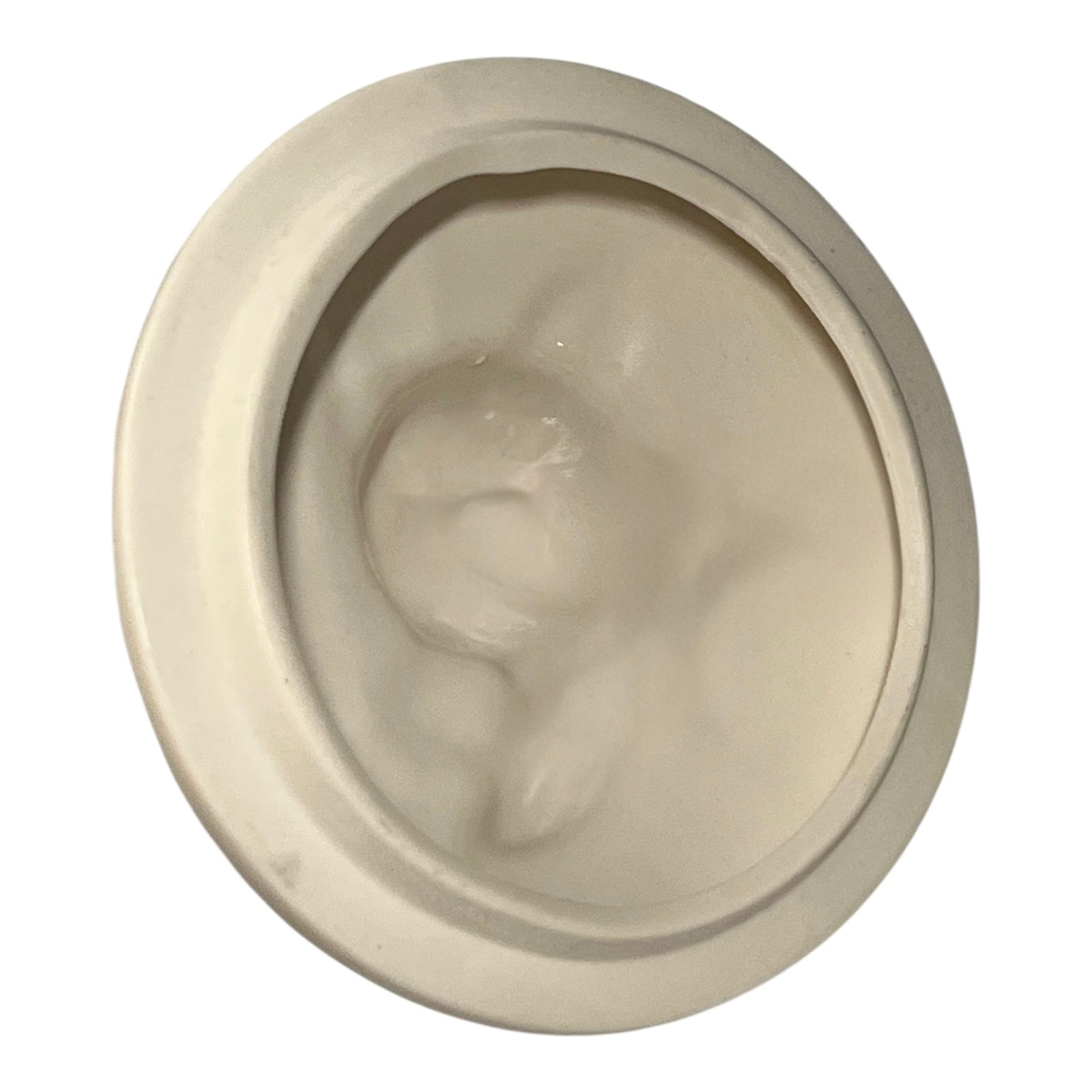 Round beige lid of a face on a white background