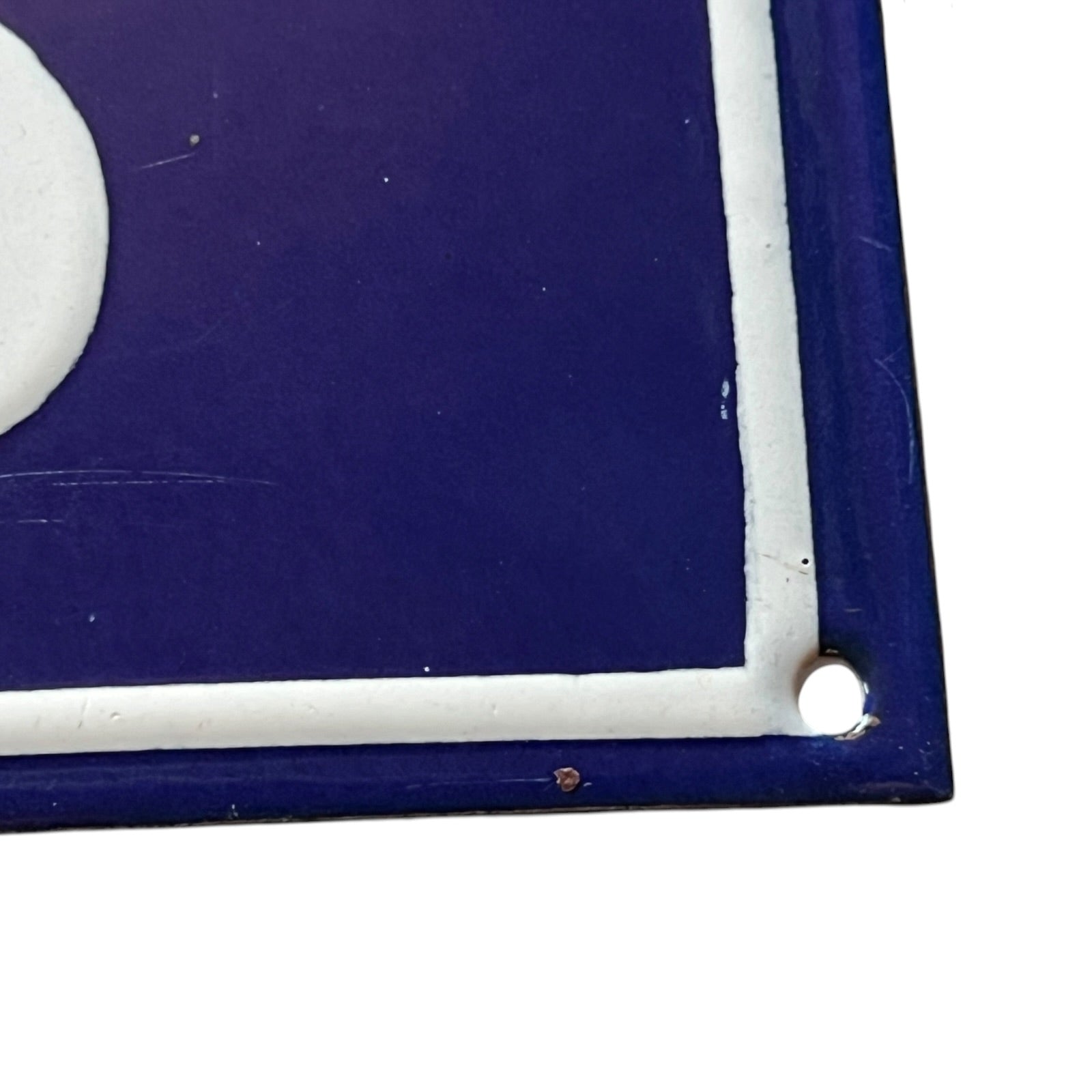 Close-up of a blue and white rectangular object with rounded corners on a white background