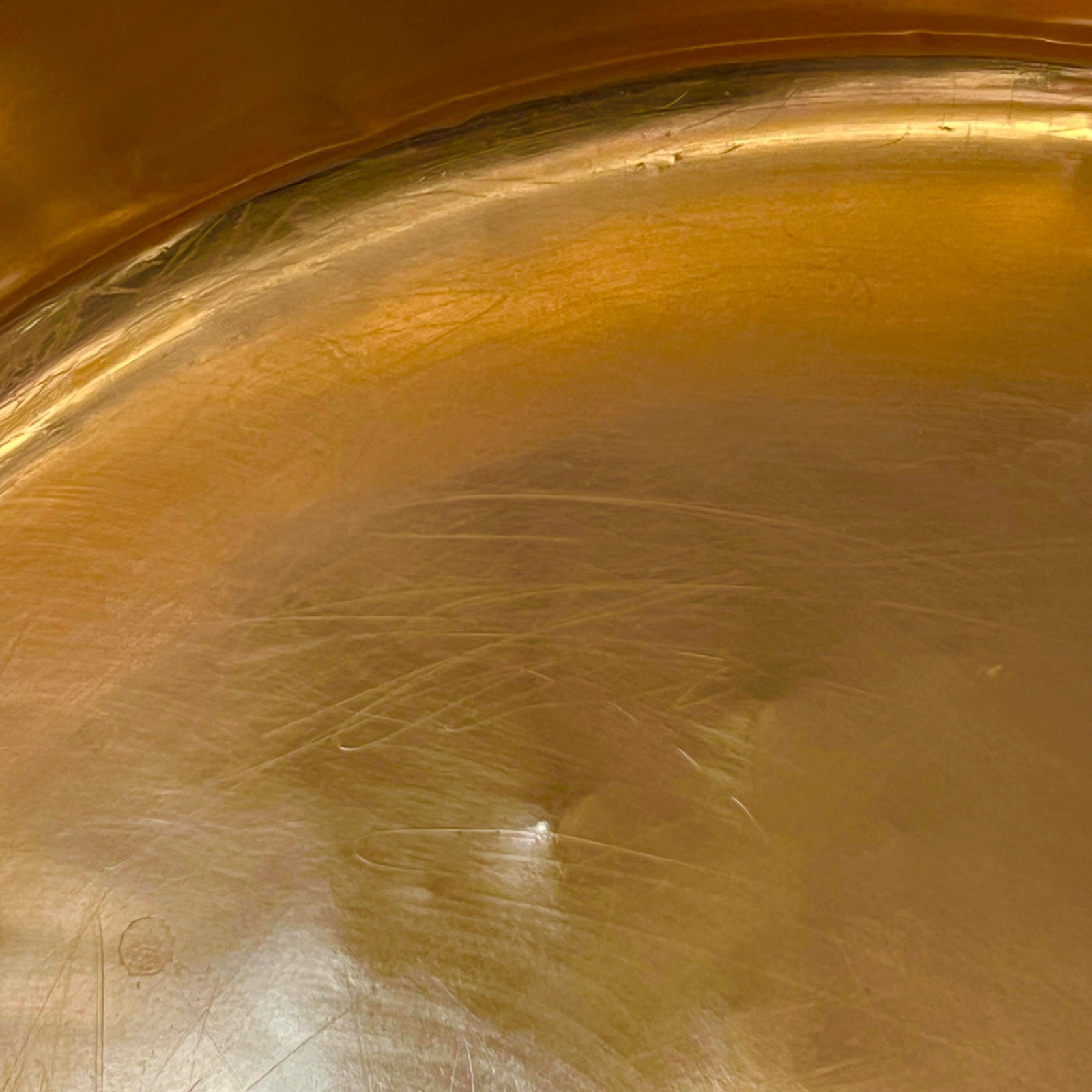 Close-up of the interior bottom of a copper sink basin.