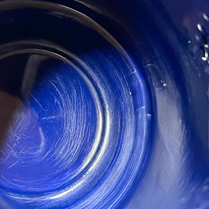 Close up of an enamel coffee pot on a white background