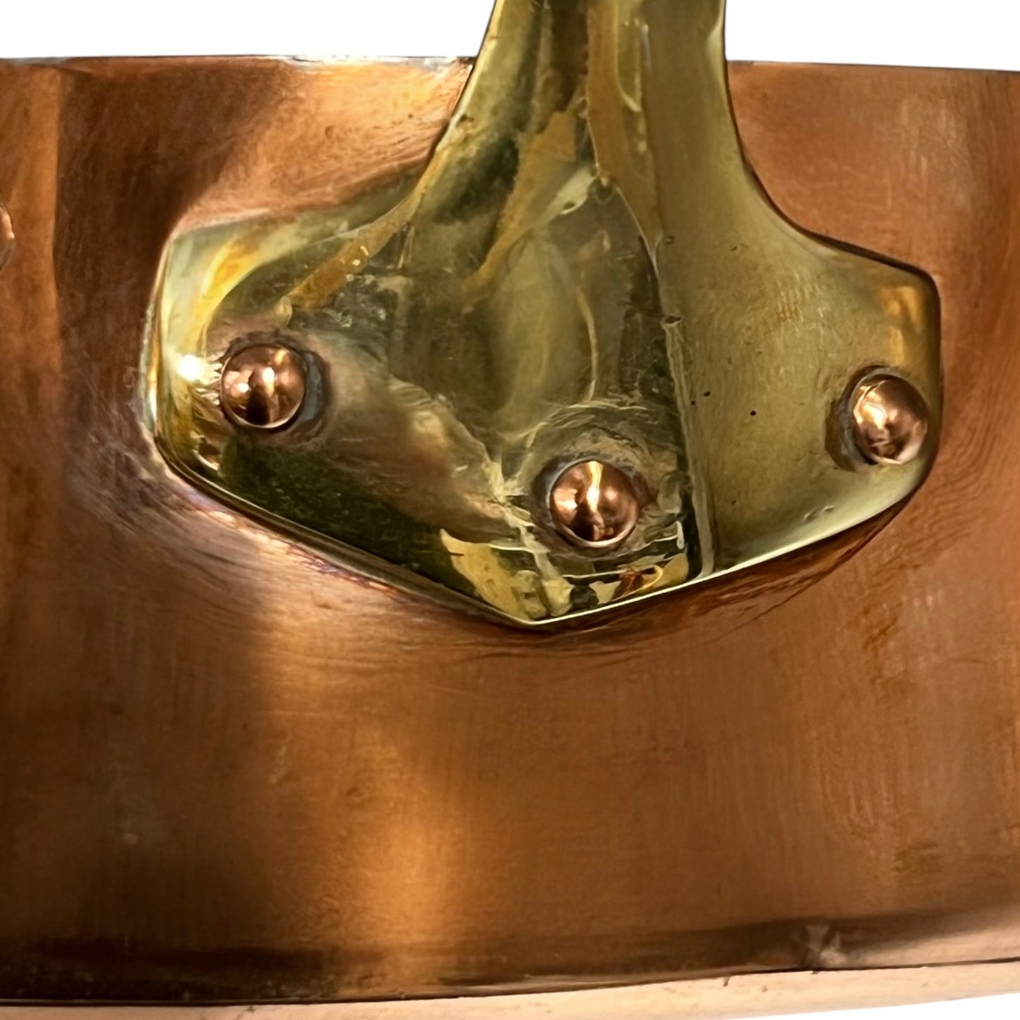 Close-up of a copper pot with a brass handle