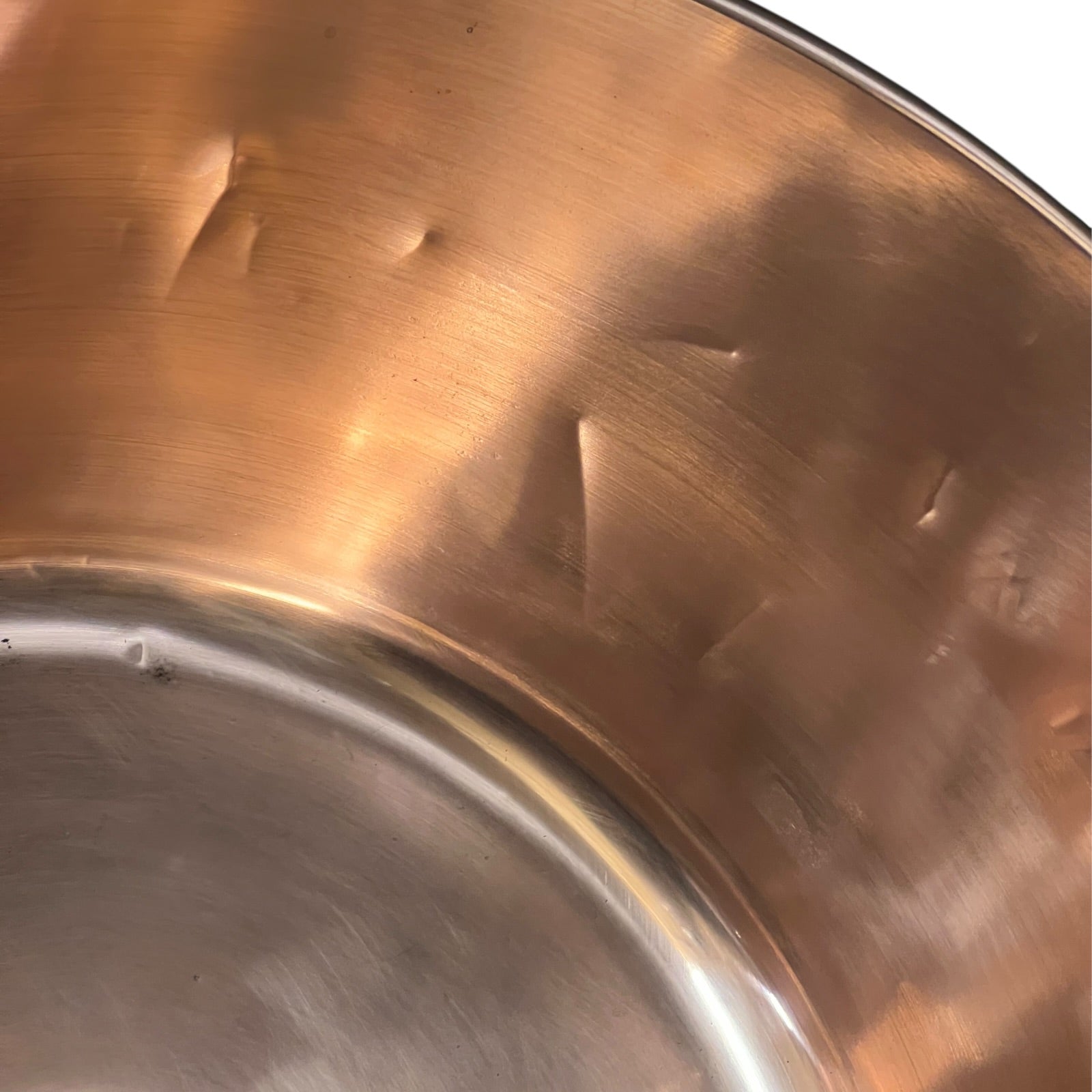 Close-up of a copper sink on a white background