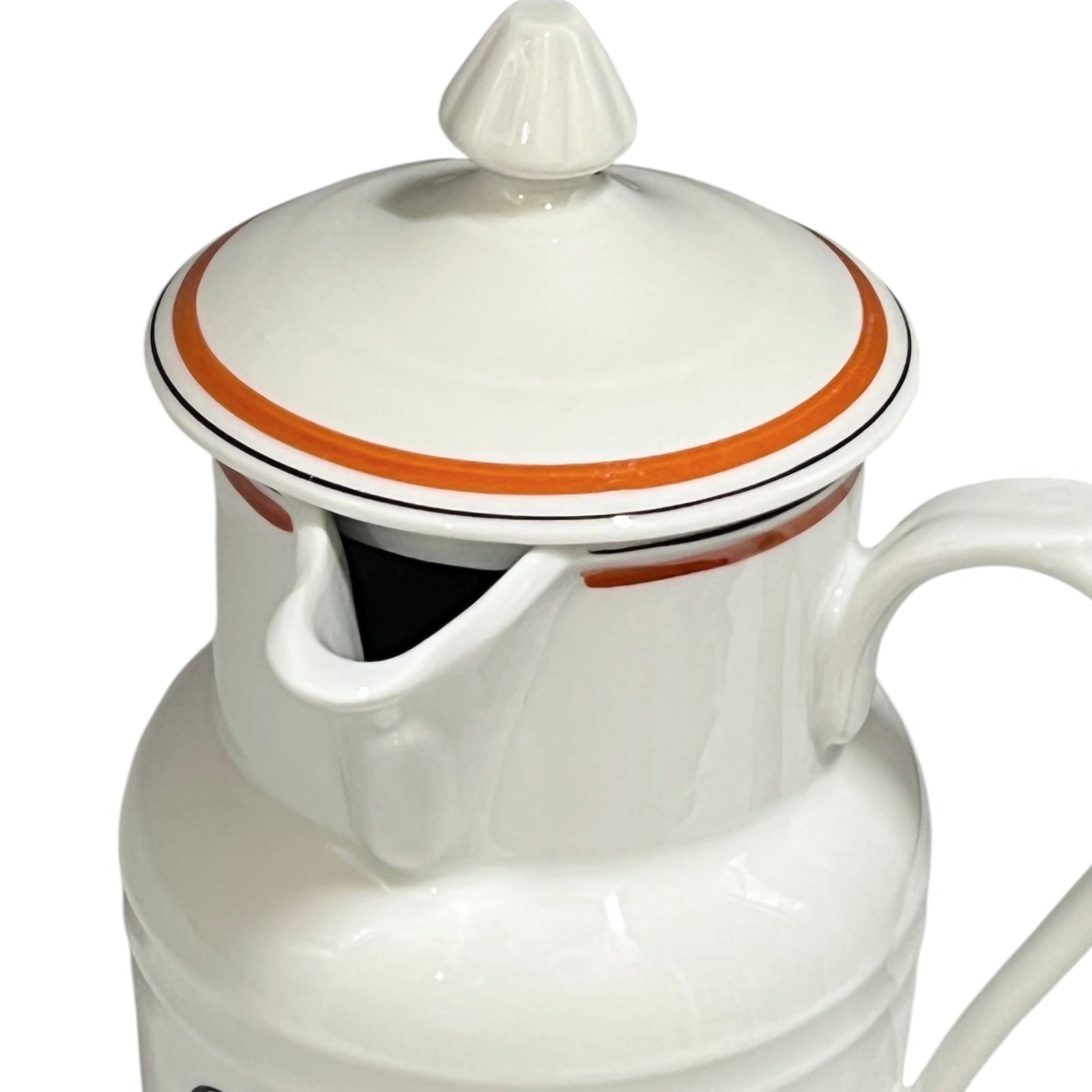 White ceramic pitcher with a lid on a white background