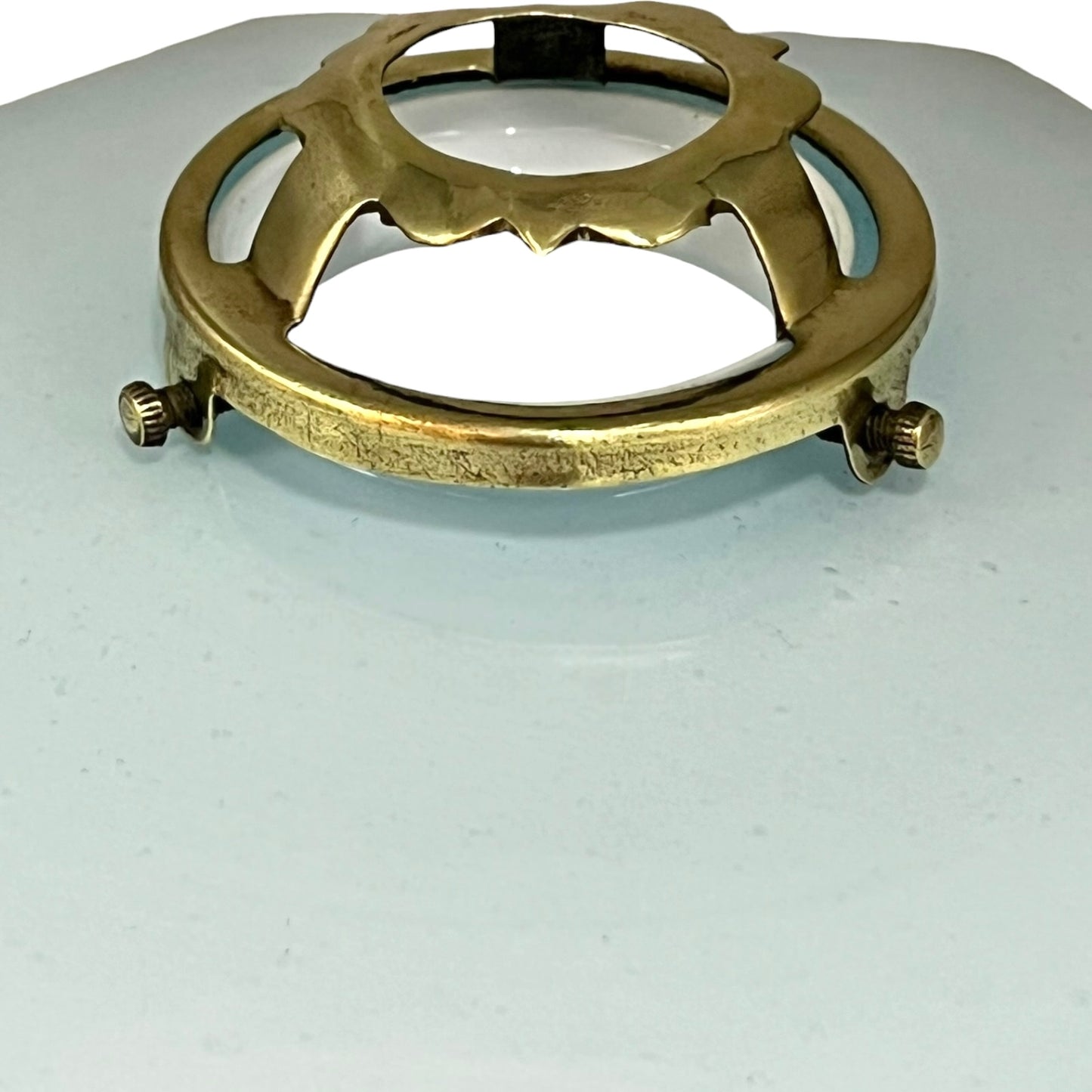 Close up of vintage blue glass lamp shade with brass fitting on a white background