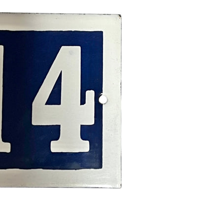 Close up of French enamel door number on a white background