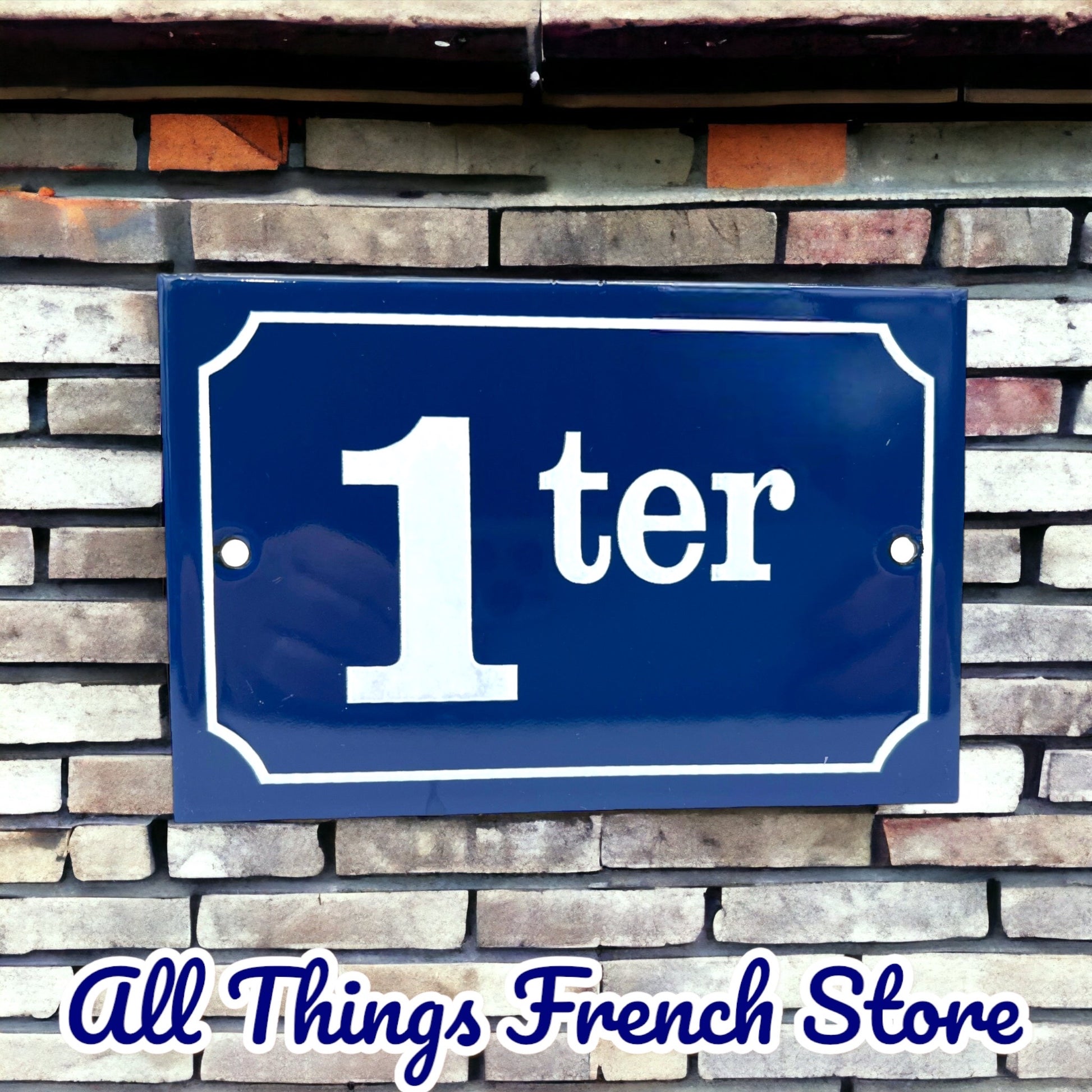 image French blue and white enamel door number 1  on a brick wall