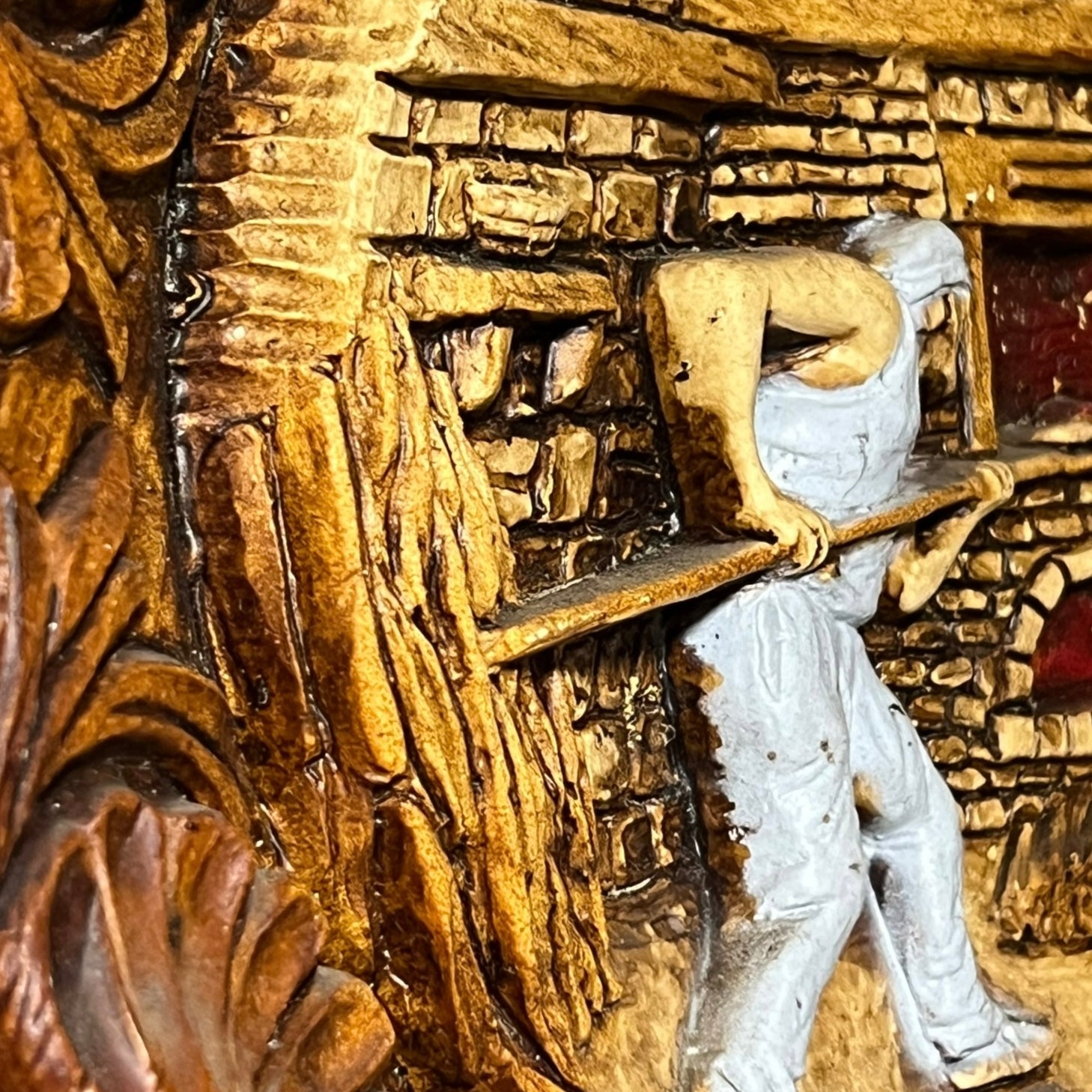 Close up of a raised 3d wood resin wall plaque of a French baker on a white background