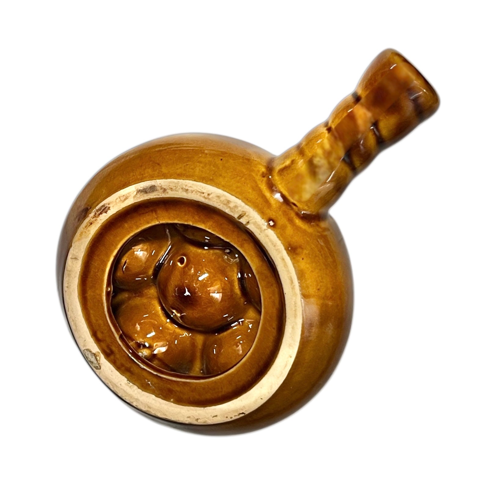 close up of a French brown ceramic escargots pot underside with multiple compartments on a white background
