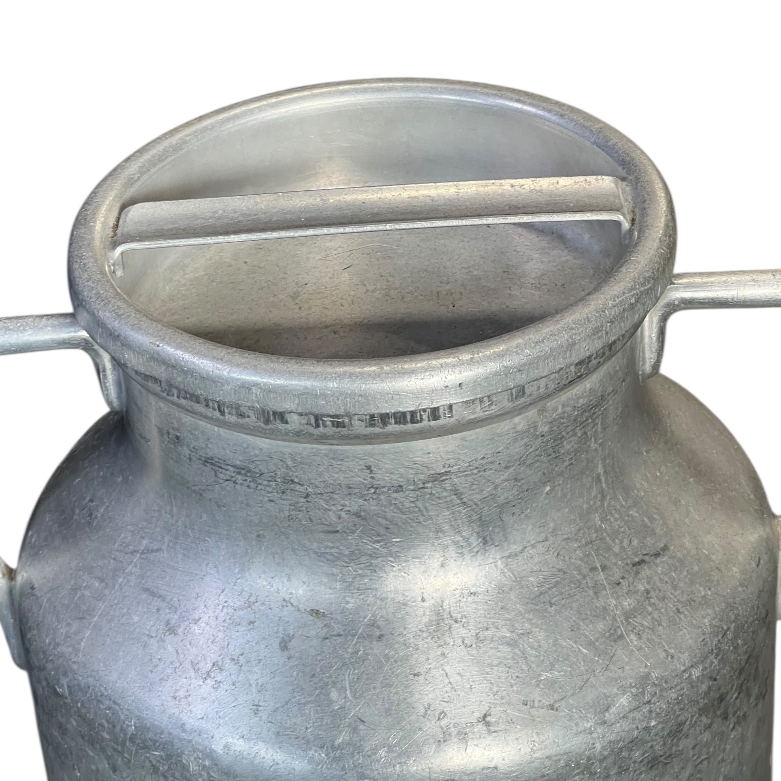 close up of metal milk churn on a white background
