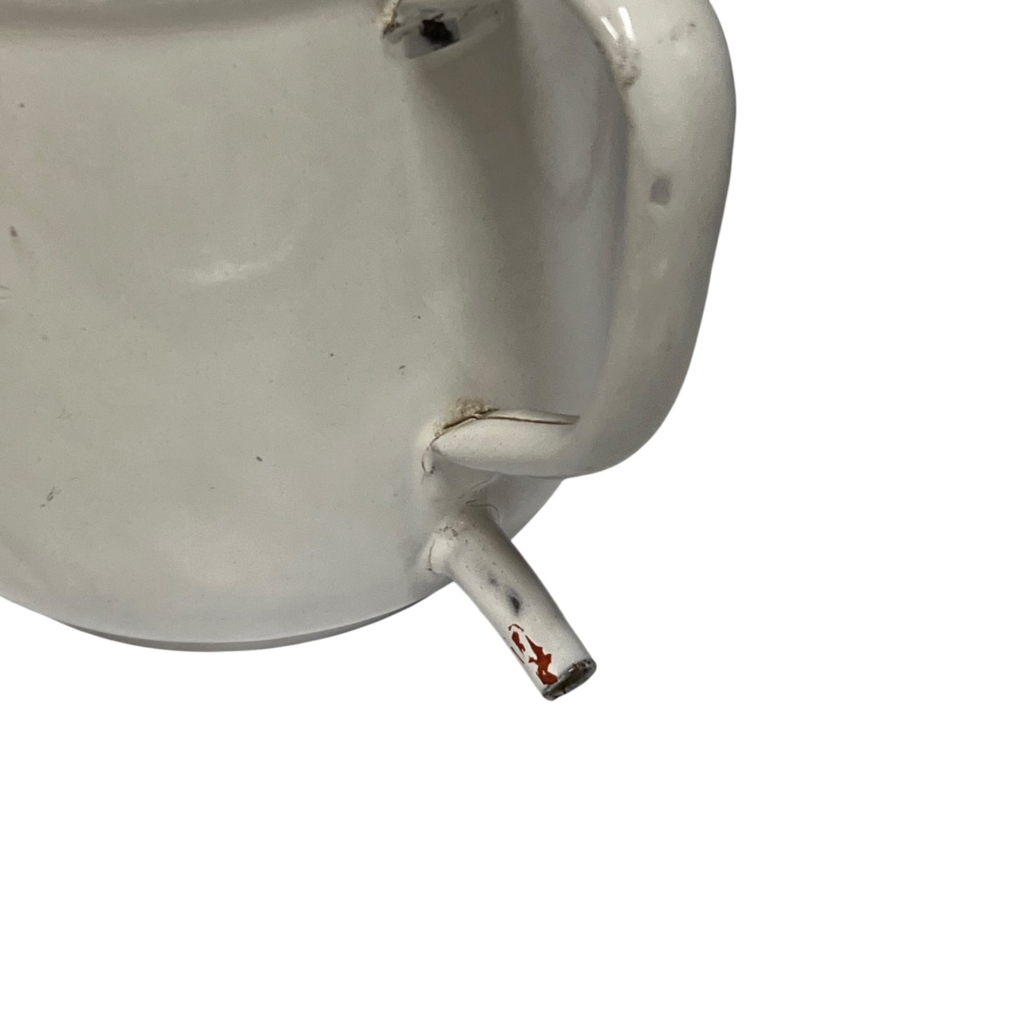 Close-up of a white mug or cup showing the side handle, rim, and a small spout with chipped red paint, isolated on a white background.