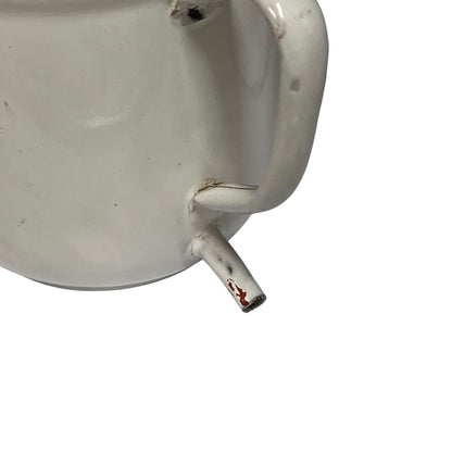 Close-up of a white mug or cup showing the side handle, rim, and a small spout with chipped red paint, isolated on a white background.