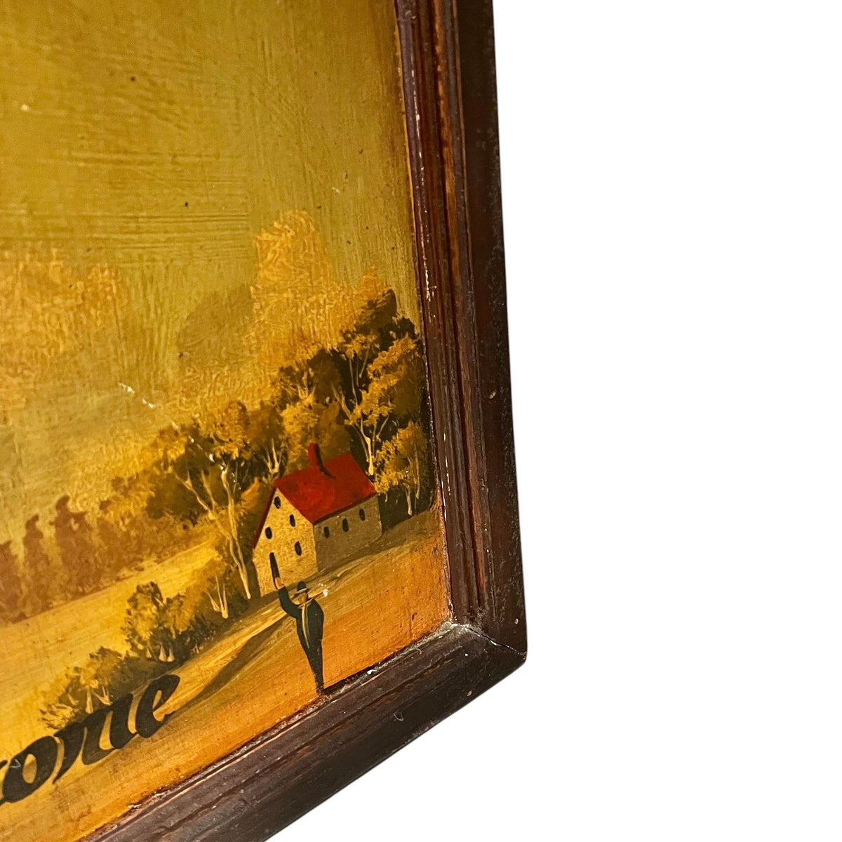 Close-up of a framed vintage aviation scene surrounded by trees under a warm yellow sky, with part of the dark wooden frame visible.