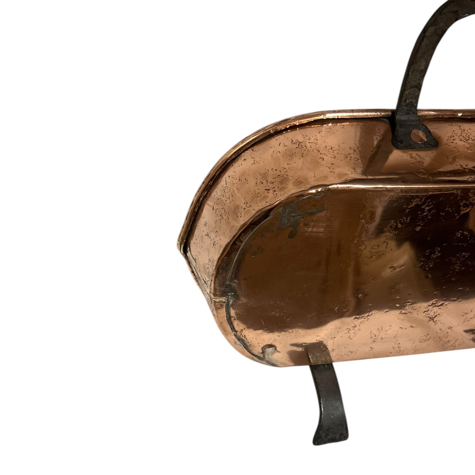 Close up of a copper roasting pan with a long handle on a white background