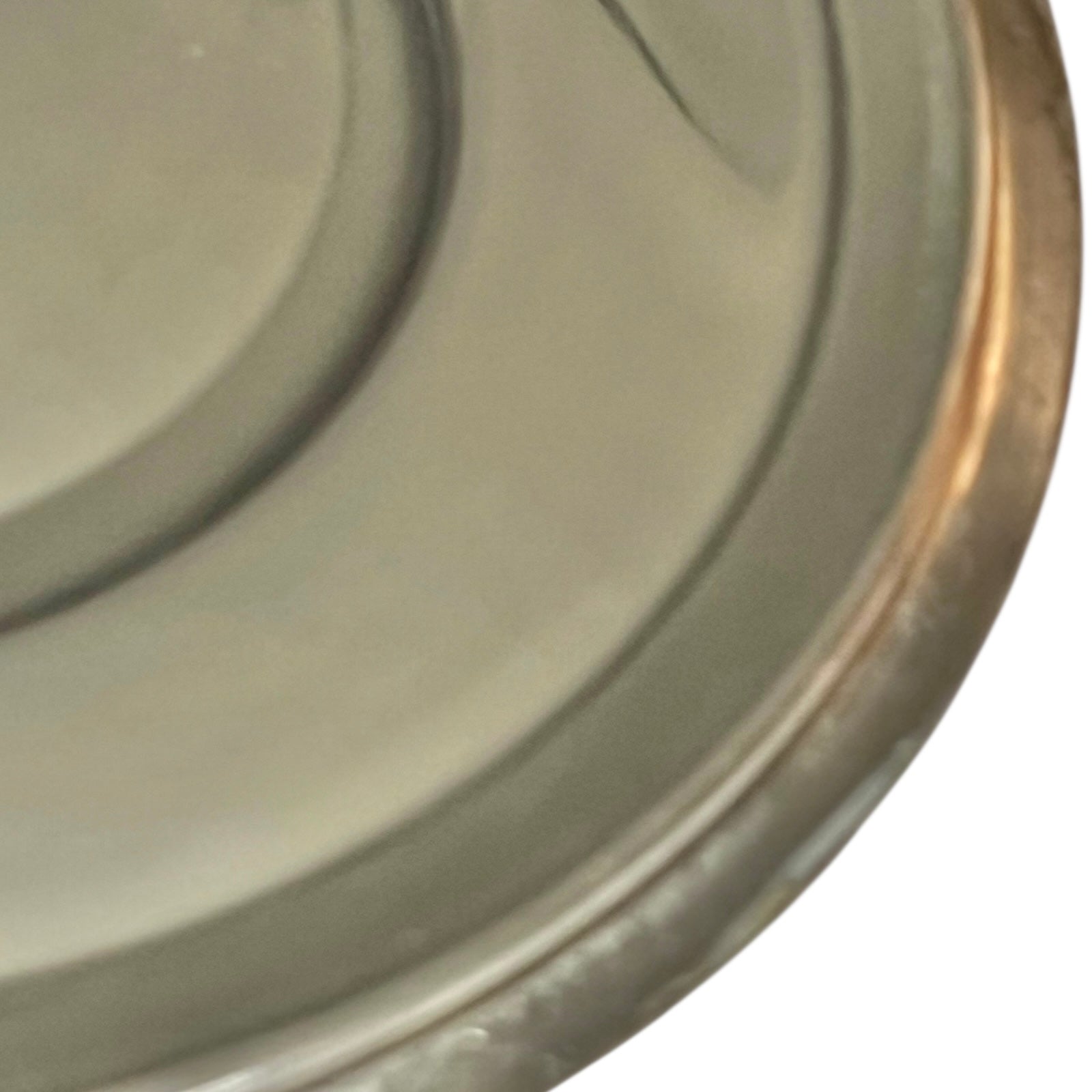 Close-up of the inside of a copper pan lid with a reflective surface