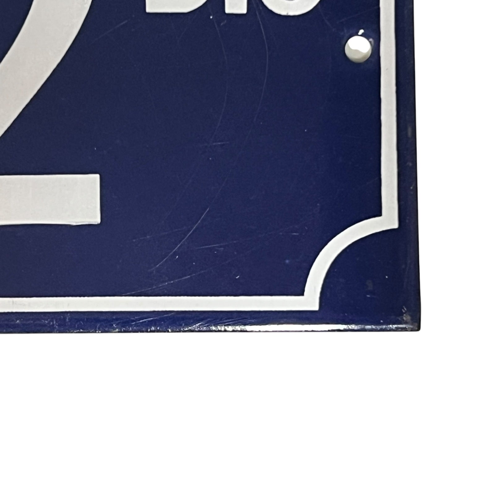 Close up of a French enamel door number 32 on a white background 