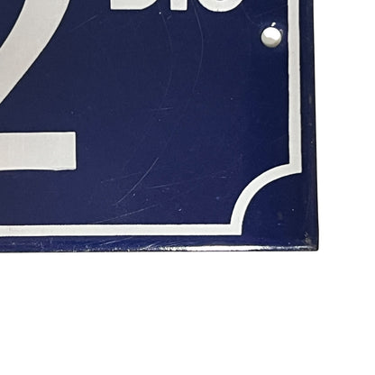 Close up of a French enamel door number 32 on a white background 
