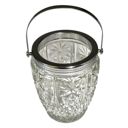 Decorative glass vintage ice bucket with metal collar and handle on a white background