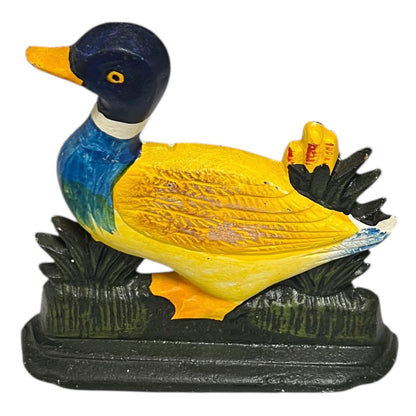 Colourful cast iron duck doorstop on a white background