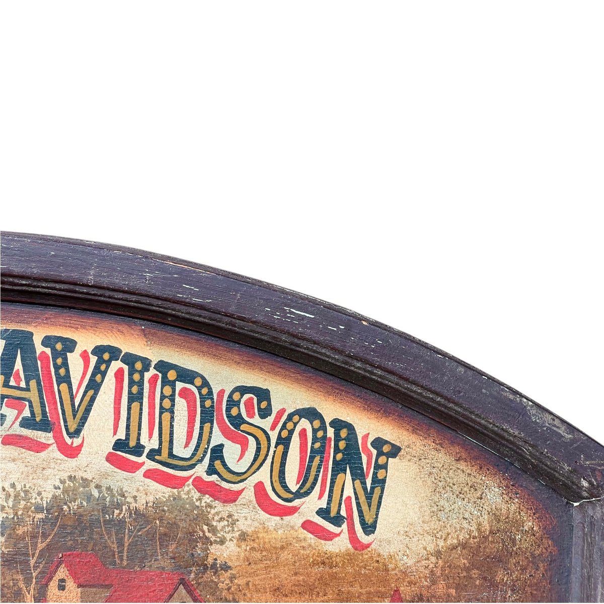 Close-up of a vintage painted sign showing part of the word "DAVIDSON" in large stylized letters over a rustic landscape scene, with a dark wooden frame against a white background.
