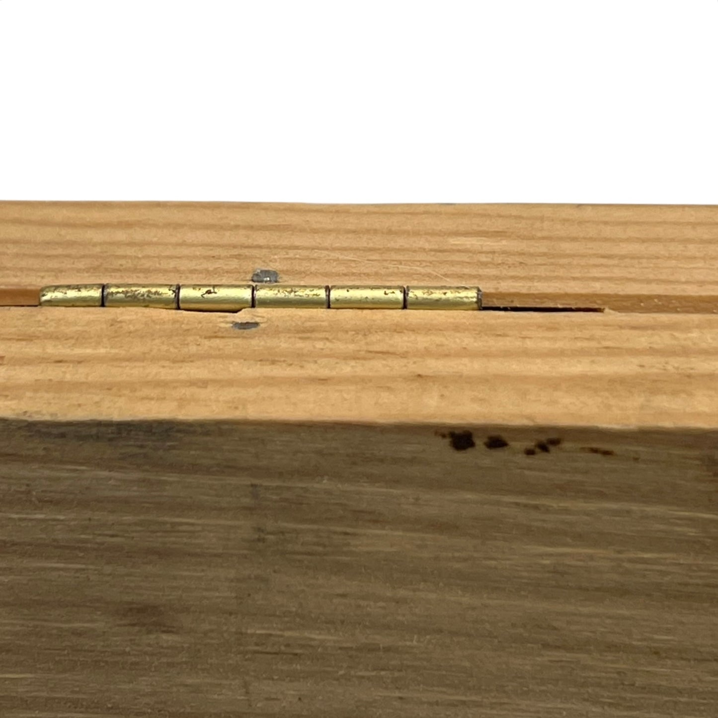 Wooden surface with a brass hinge